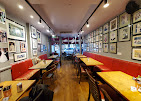 Long view of Café Diana with red banquettes and walls of Princess Diana photographs