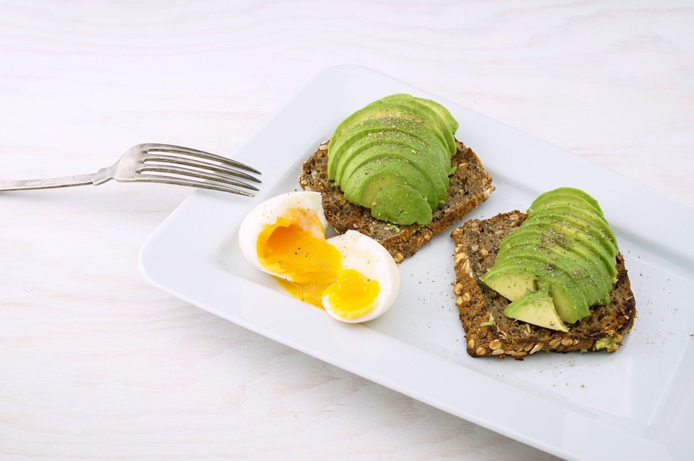 Avocado toast topped with soft egg