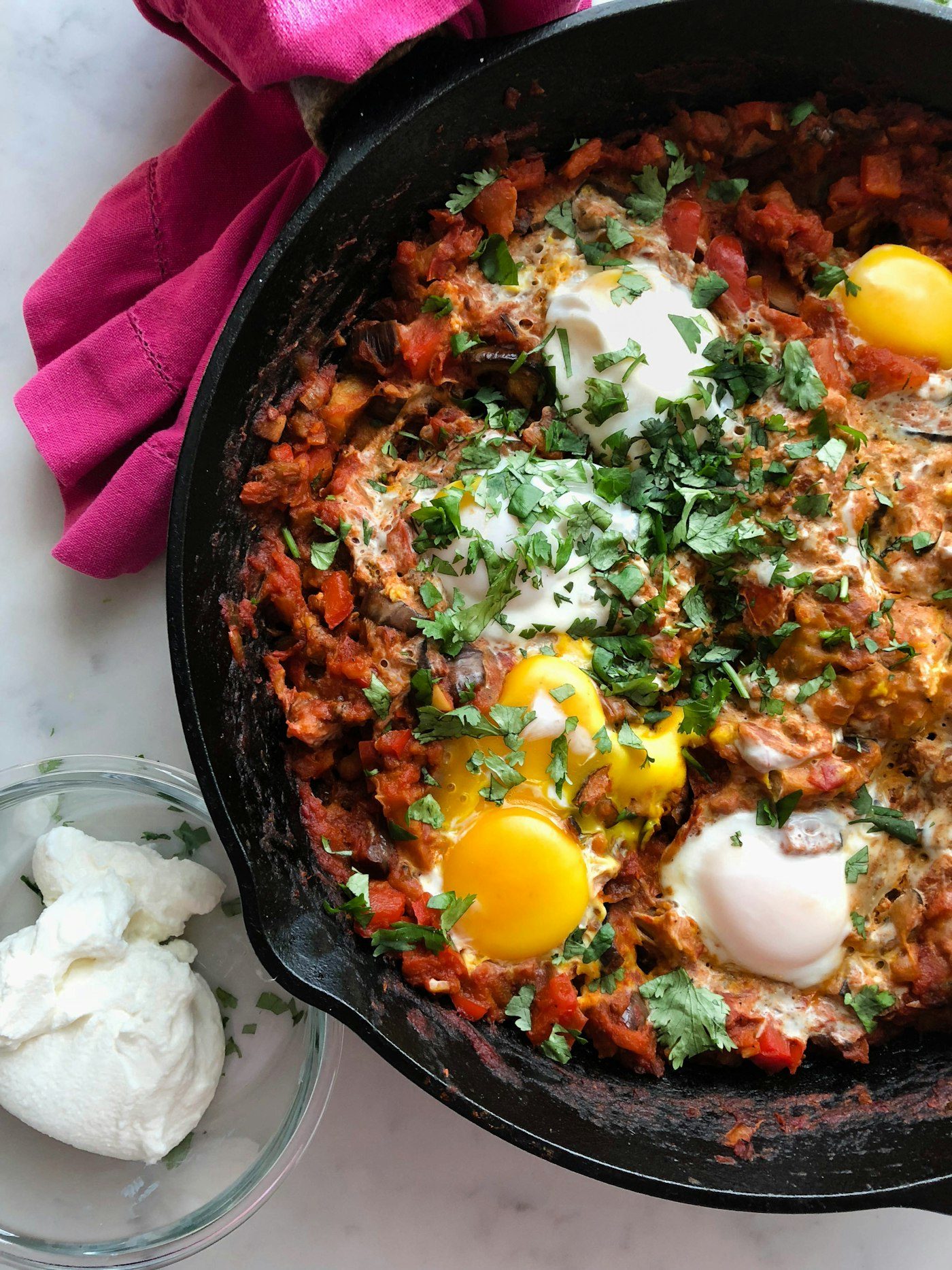 Shakshuka skillet with eggs and meat
