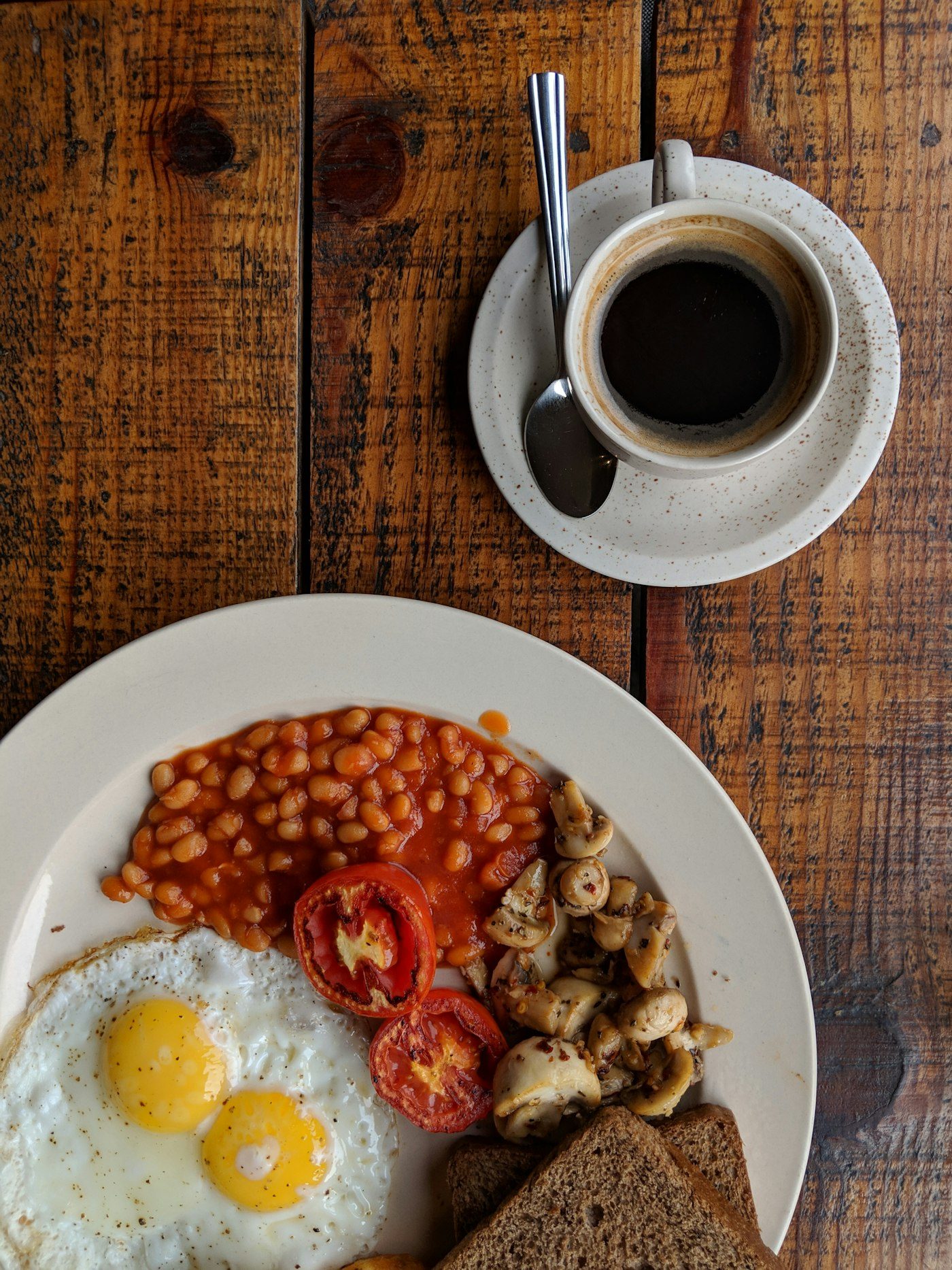 Vegetarian breakfast with eggs, mushrooms, tomatoes and toast